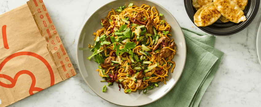 A delicious serving of noodles with vegetables, representing Noodles & Company's birthday reward.